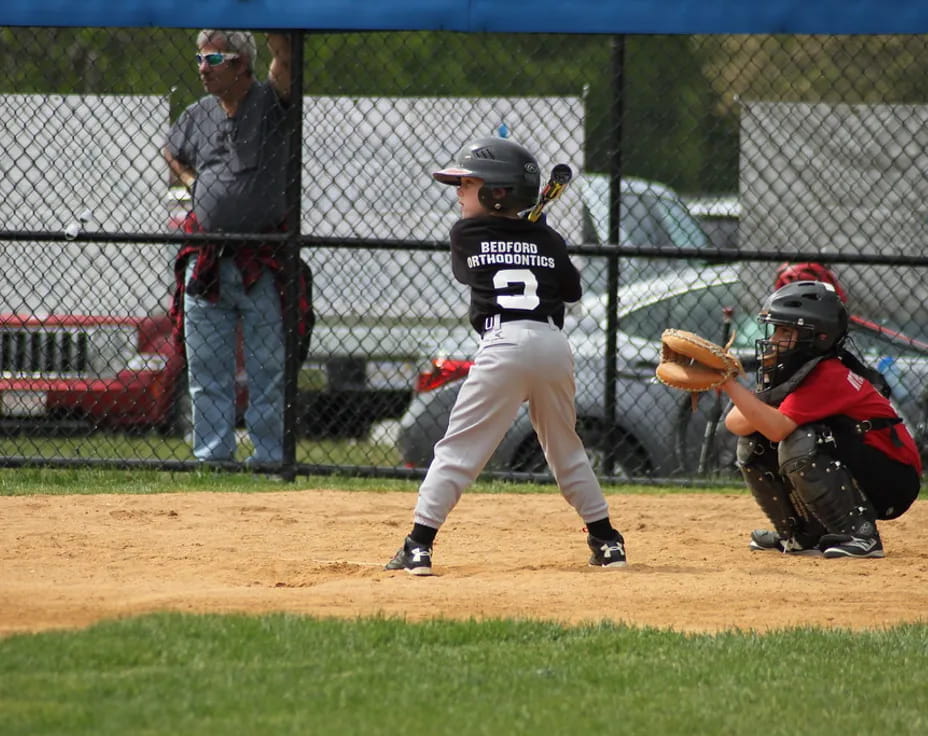 a kid swinging a baseball bat