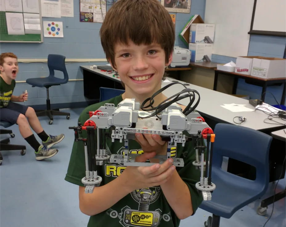 a boy holding up his hand