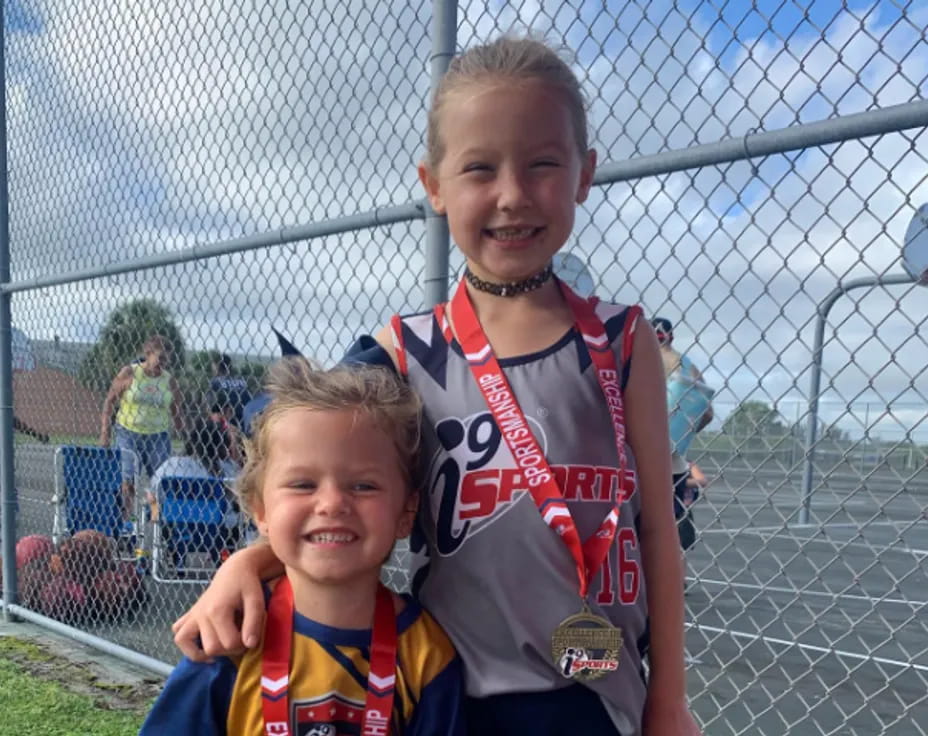 a boy and girl posing for a picture