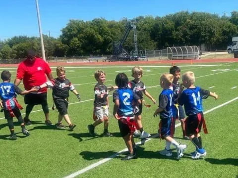 a group of kids playing football