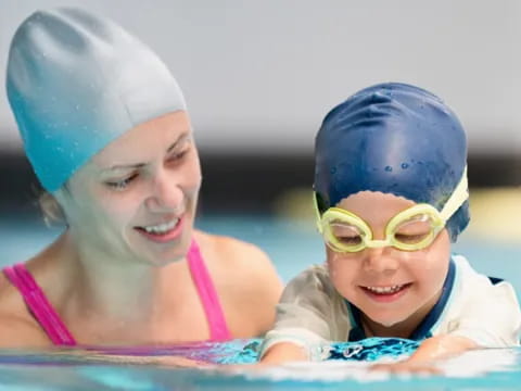 a person and a child in a pool