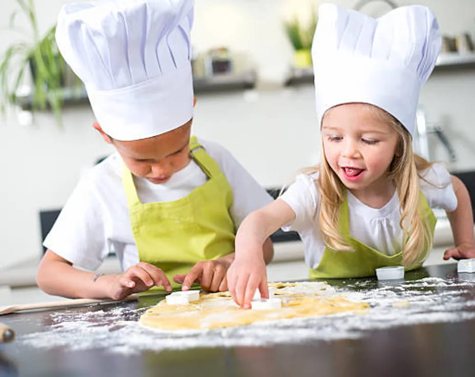 a couple of kids wearing chef hats