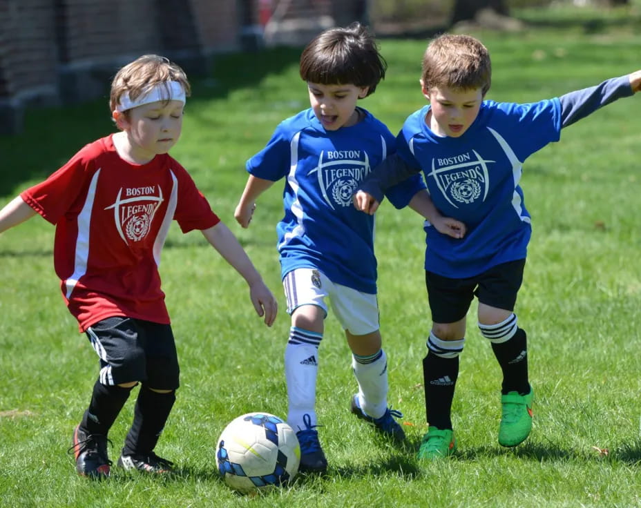 kids playing football on a field