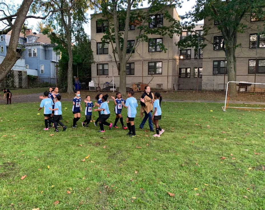 a group of kids playing football