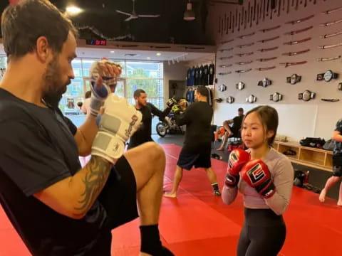 a person and a girl in a gym