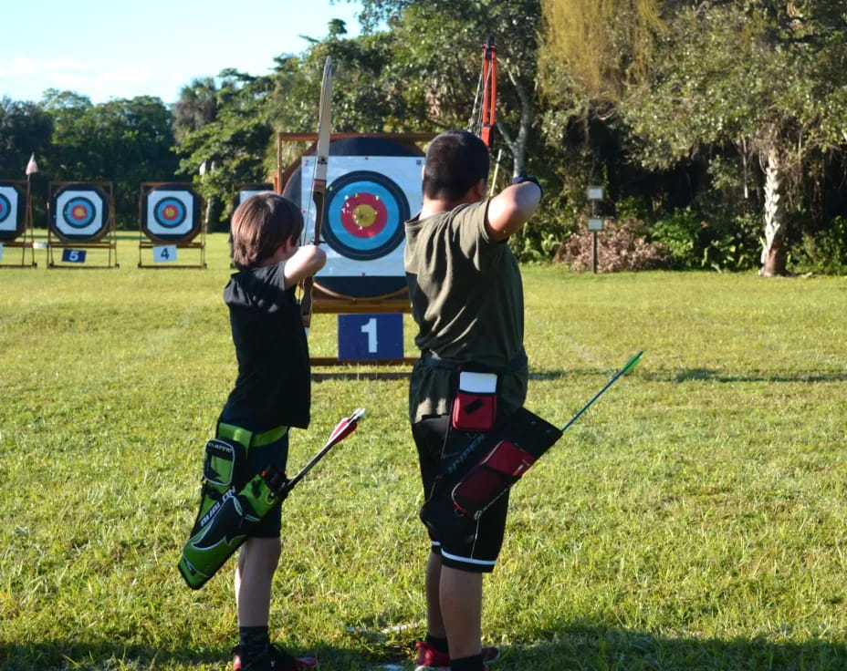 two boys playing with sticks