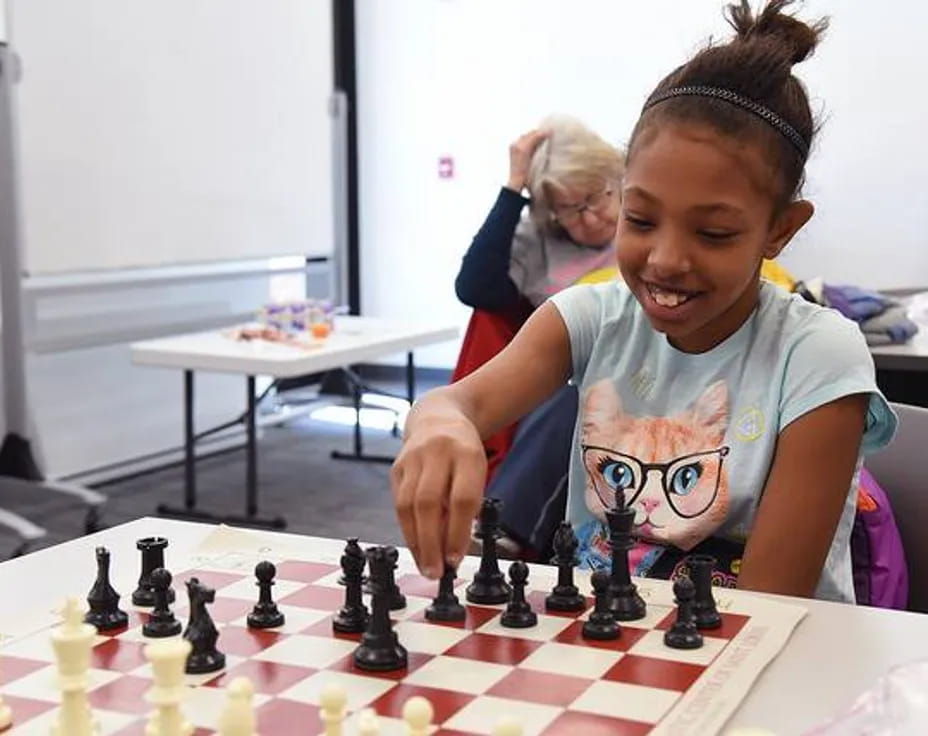 a young girl playing chess