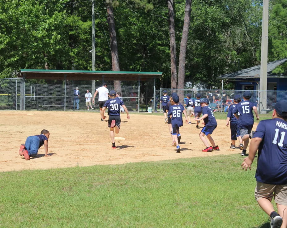 a group of people playing baseball