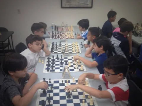 a group of people playing chess