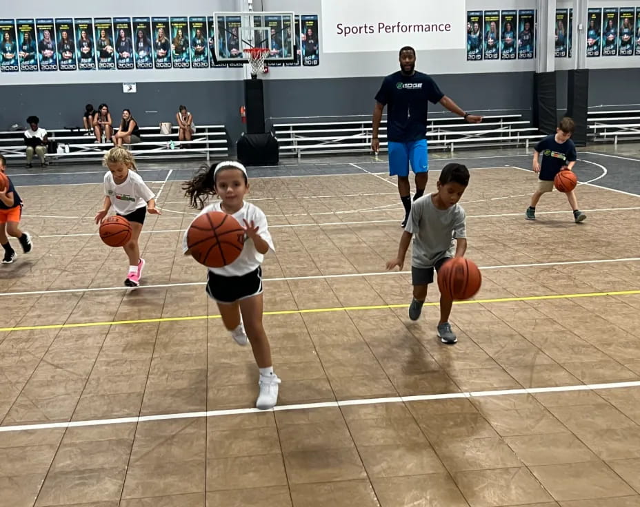 a group of kids playing basketball