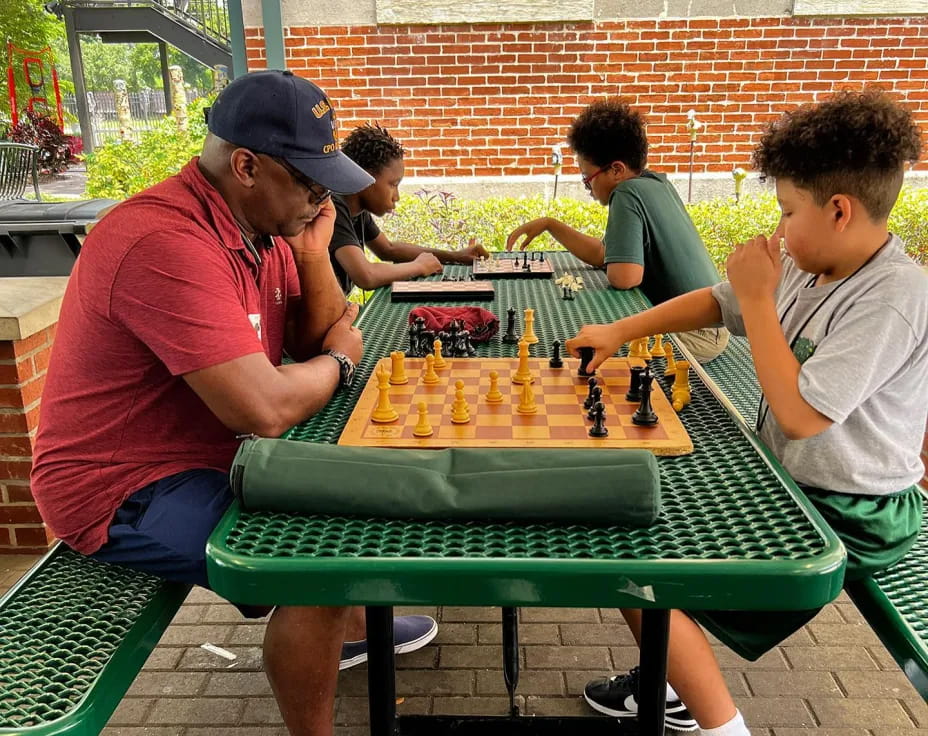 a group of people playing chess