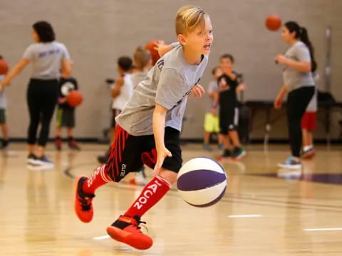 a young boy playing basketball