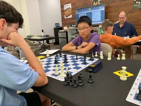 a group of people playing chess