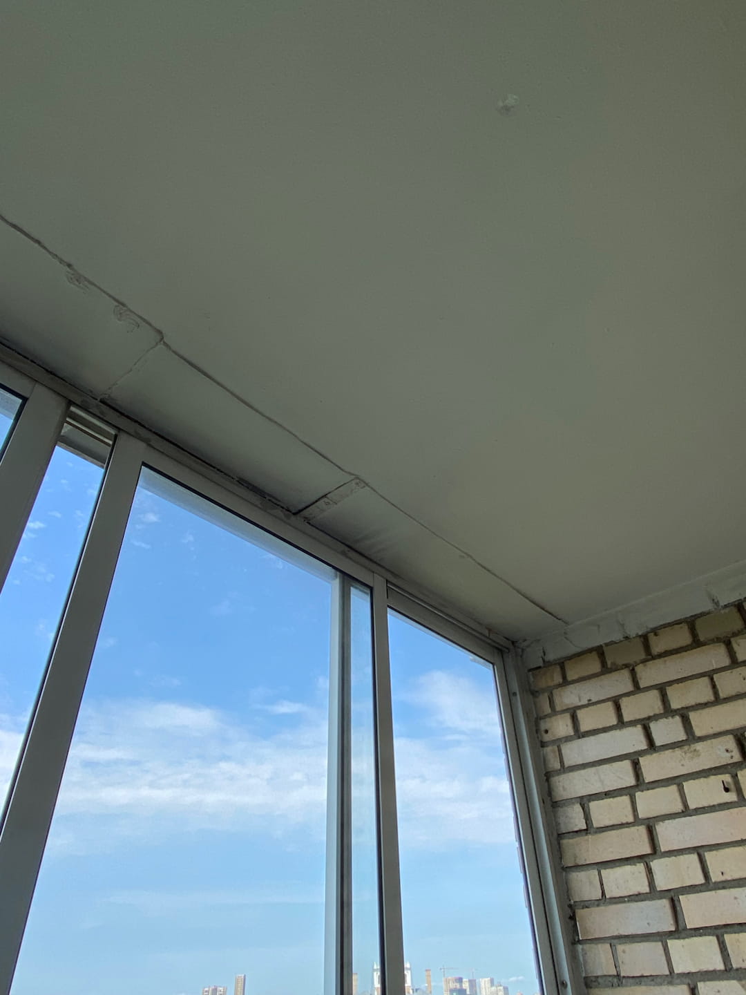 a view looking through a window at a brick building