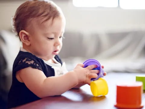 a baby playing with a toy