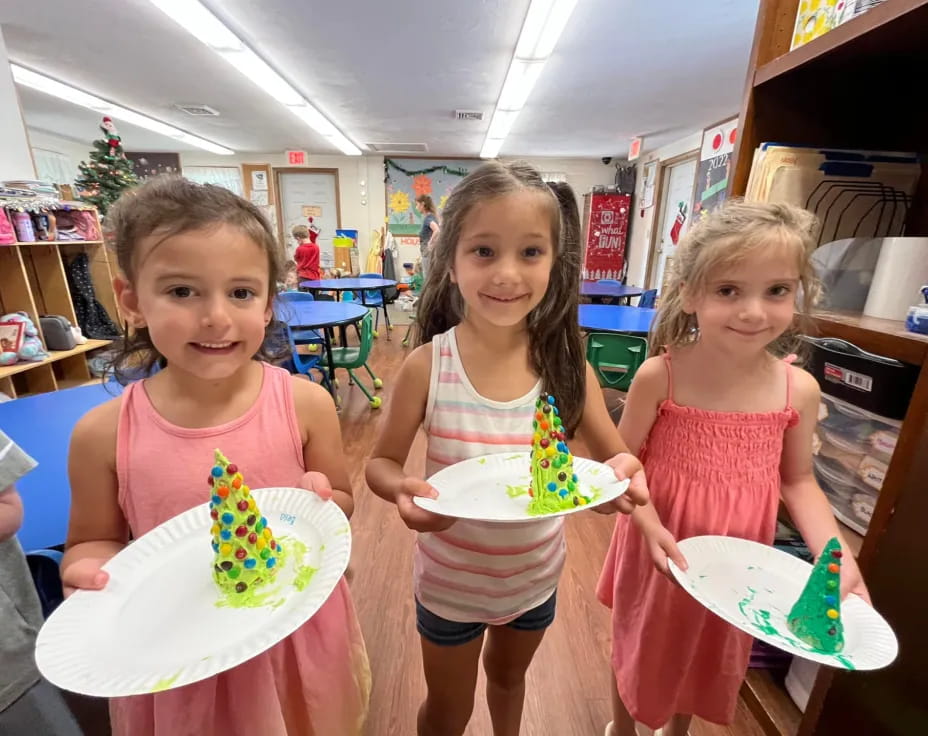 a group of girls holding cake