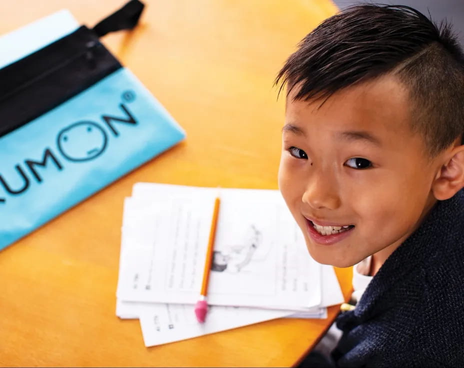 a boy sitting at a desk