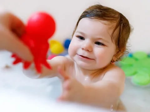 a baby with a hand on her head