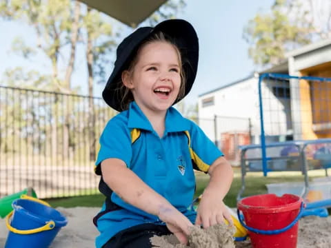 a child playing in a sandbox