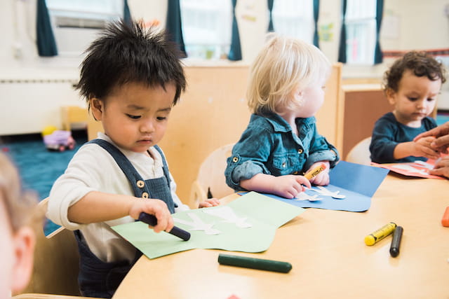 a few children sitting at a table