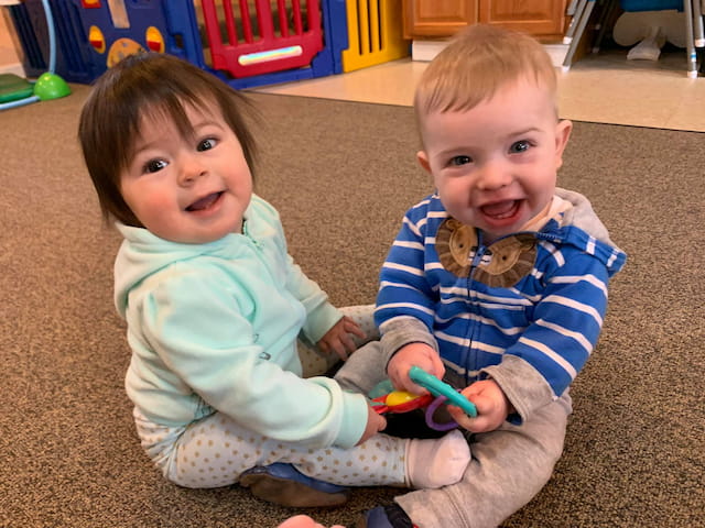 a couple of kids playing with a toy
