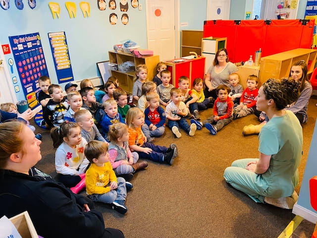 a group of children sitting in a classroom