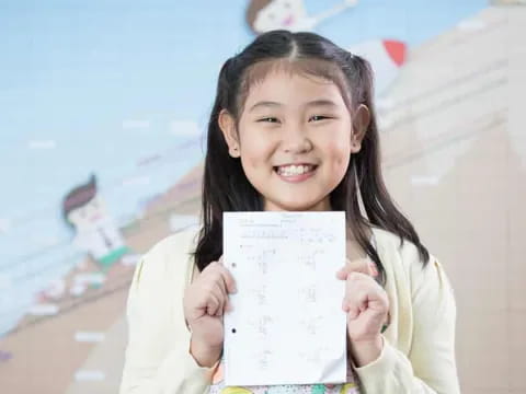 a girl holding a piece of paper