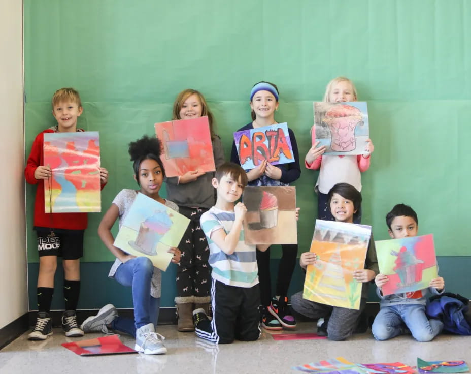 a group of children holding books