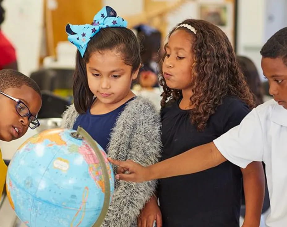 a group of people around a globe
