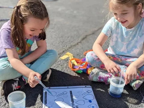 a couple of young girls painting