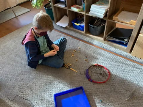 a child with a laptop and scissors