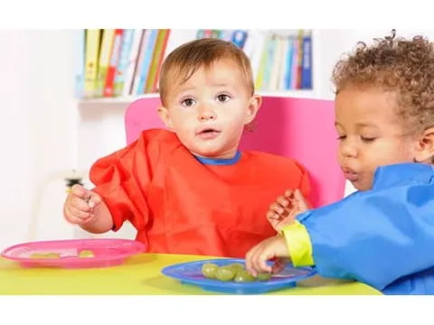 a couple of young boys eating