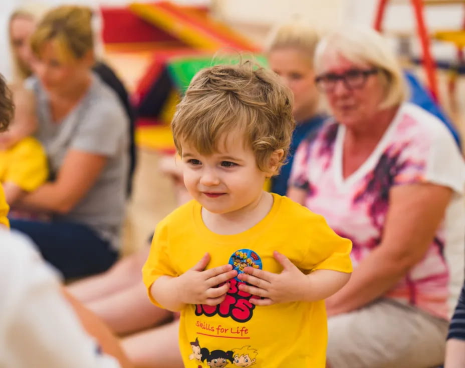 a boy in a yellow shirt