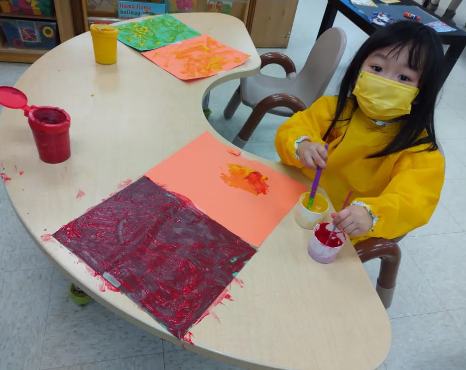 a girl painting on a table