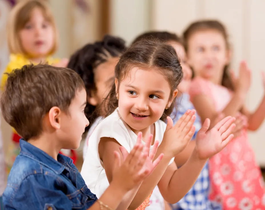 a group of children clapping