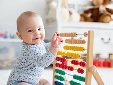 a baby holding a toy