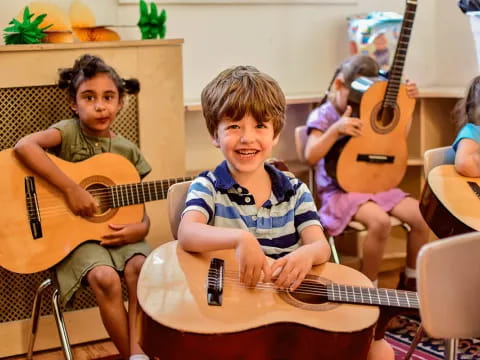 a group of kids playing guitars
