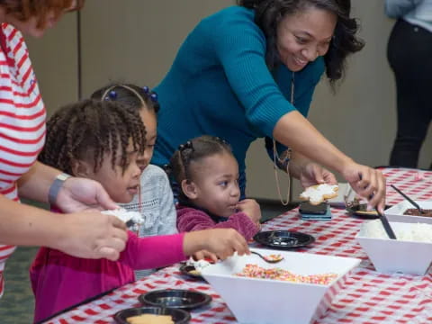a group of people are eating cake
