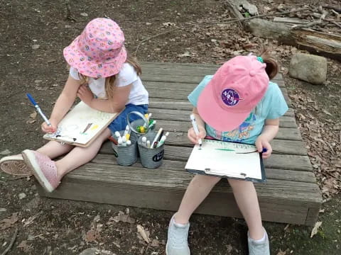 two girls sitting on a bench