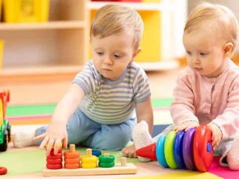 two babies playing with toys