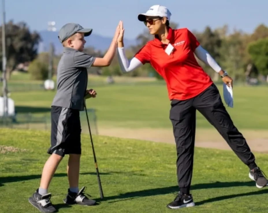 a man and a woman playing golf