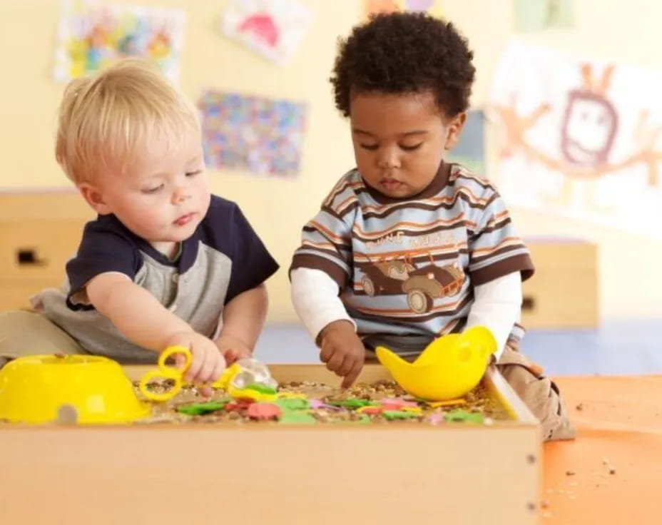 two boys playing with toys