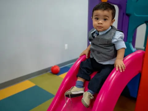 a baby sitting in a chair