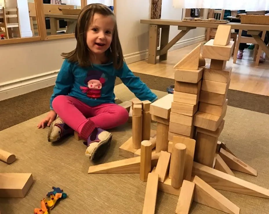 a girl sitting on a wooden structure