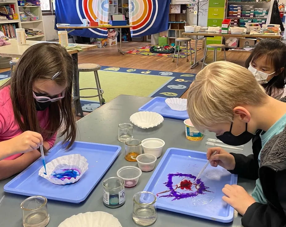 a group of children painting