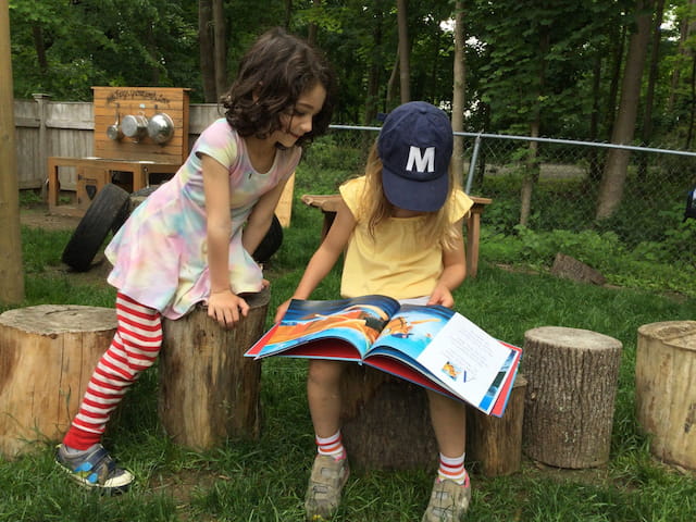 a person and a child sitting on a bench