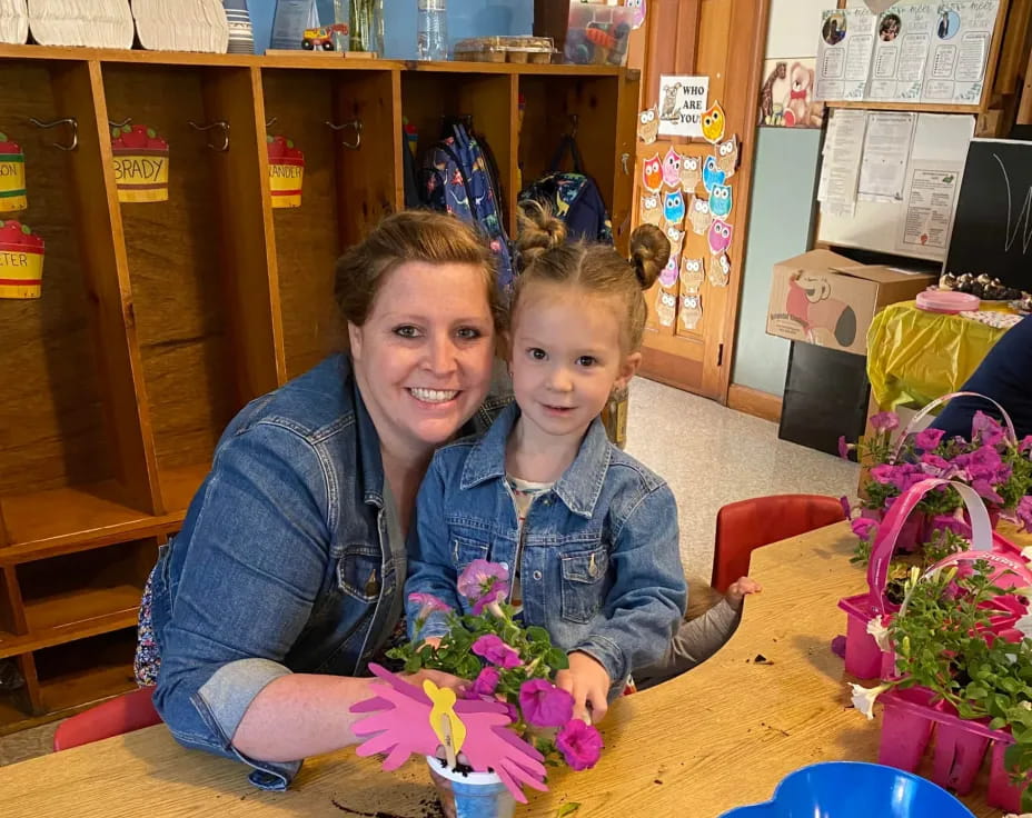 a woman and a child holding flowers
