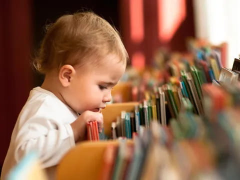a young boy coloring on a paper