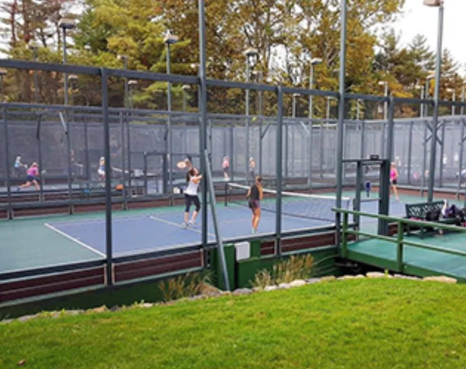 a group of people playing tennis