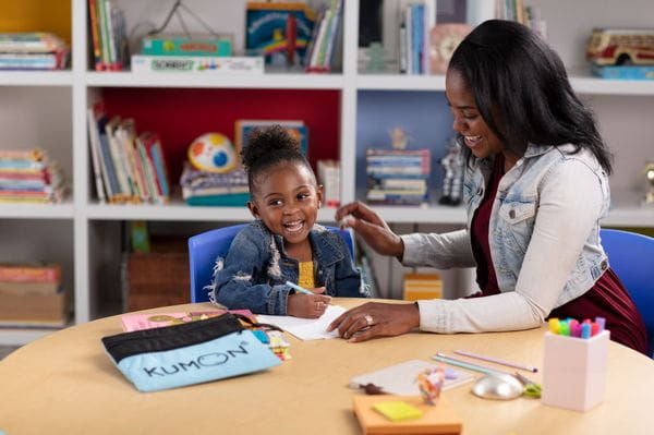 a person and a child sitting at a table